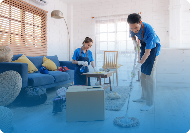 People cleaning a living room with supplies.