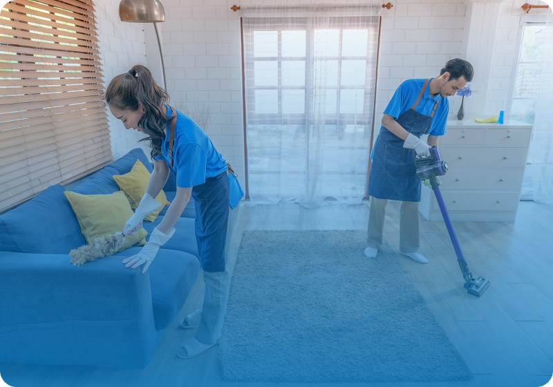Two people cleaning a living room.